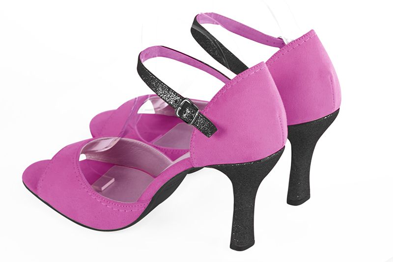 Shocking pink and gloss black women's closed back sandals, with an instep strap. Round toe. Very high spool heels. Rear view - Florence KOOIJMAN